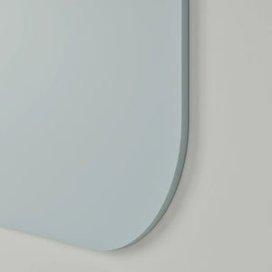 Minimalist close-up of Chameleon Curve frameless whiteboard, rounded corners, sleek and modern on a light gray wall—contemporary style.