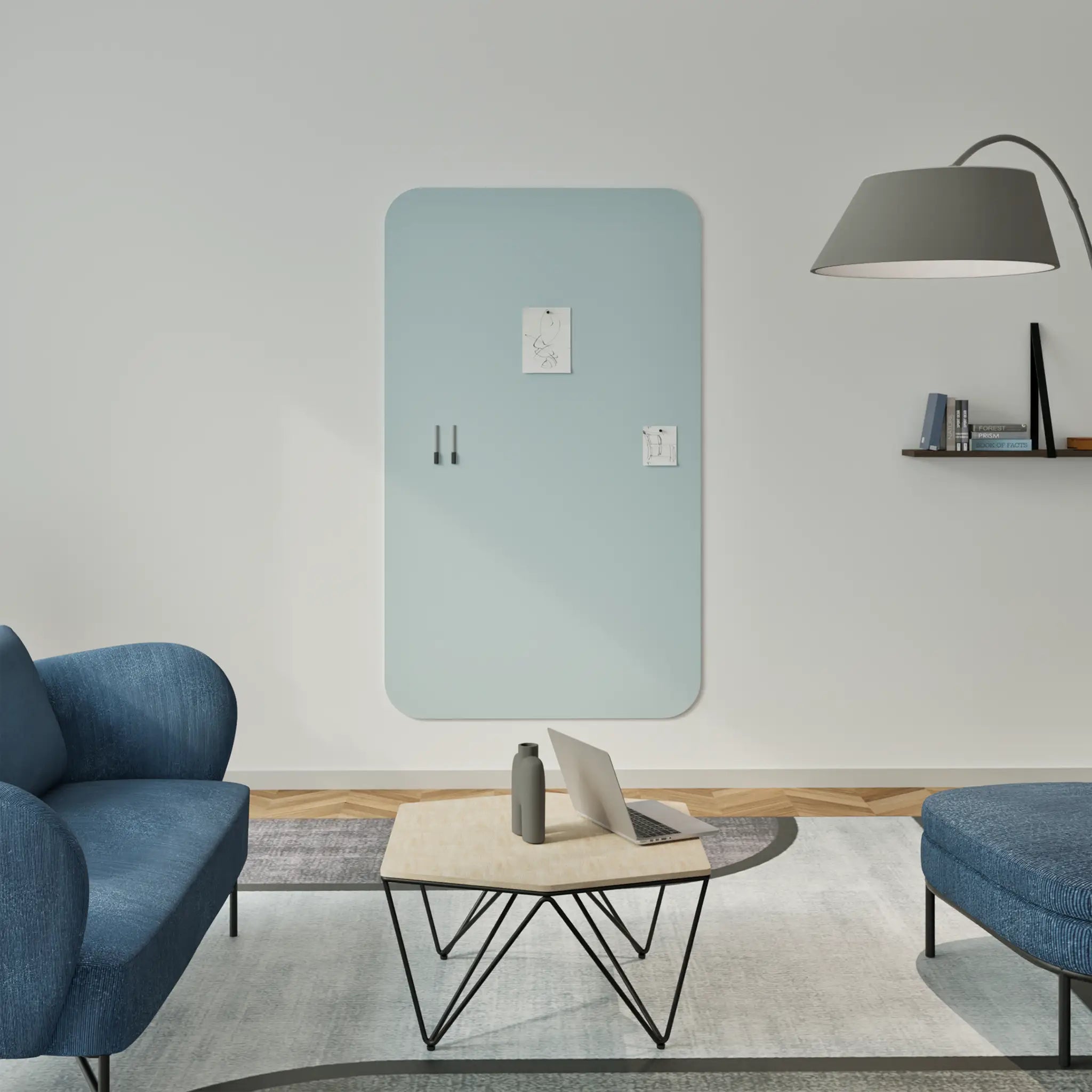 Showcase your space: sleek modern living room, blue sofas, Chameleon Curve frameless whiteboard, stylish coffee table, wall lamp.