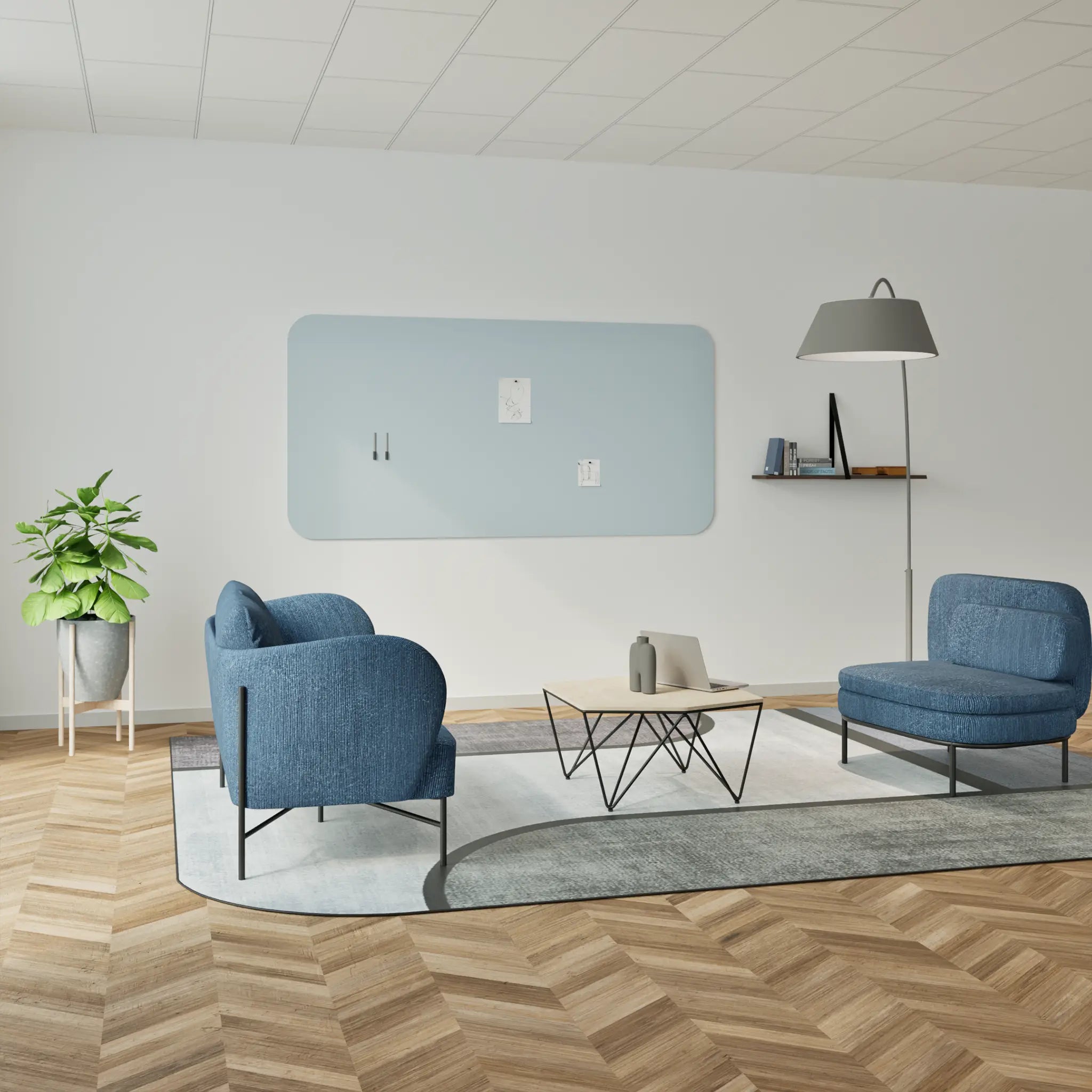 Showcase your modern lounge with blue armchairs, Chameleon Curve frameless whiteboard, light blue panel, and herringbone floor.