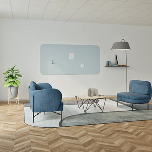 Showcase your modern lounge with blue armchairs, Chameleon Curve frameless whiteboard, light blue panel, and herringbone floor.