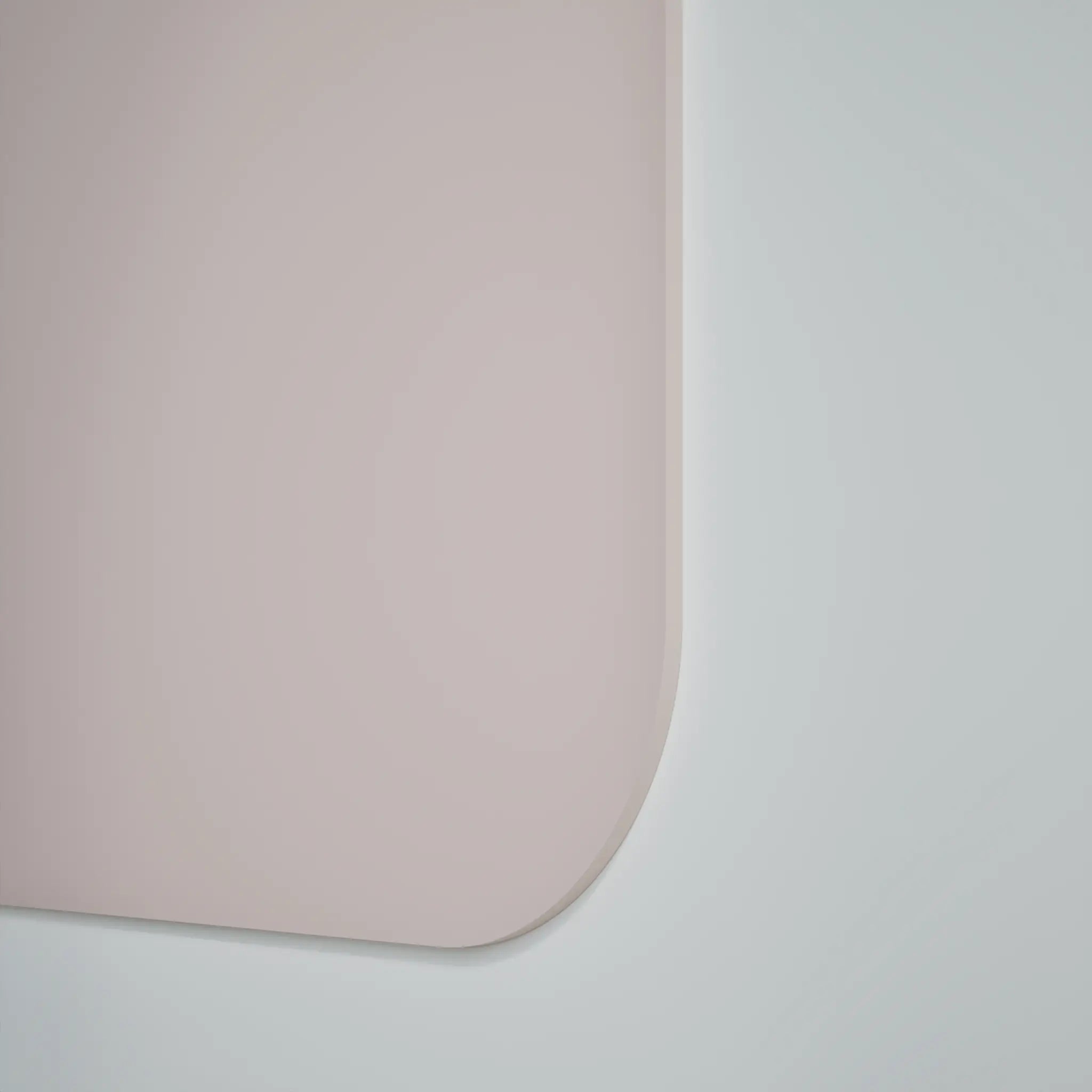 Close-up of Chameleon Curve Wall magnetic whiteboard with smooth, pink ceramic steel surface and rounded corner for modern offices.