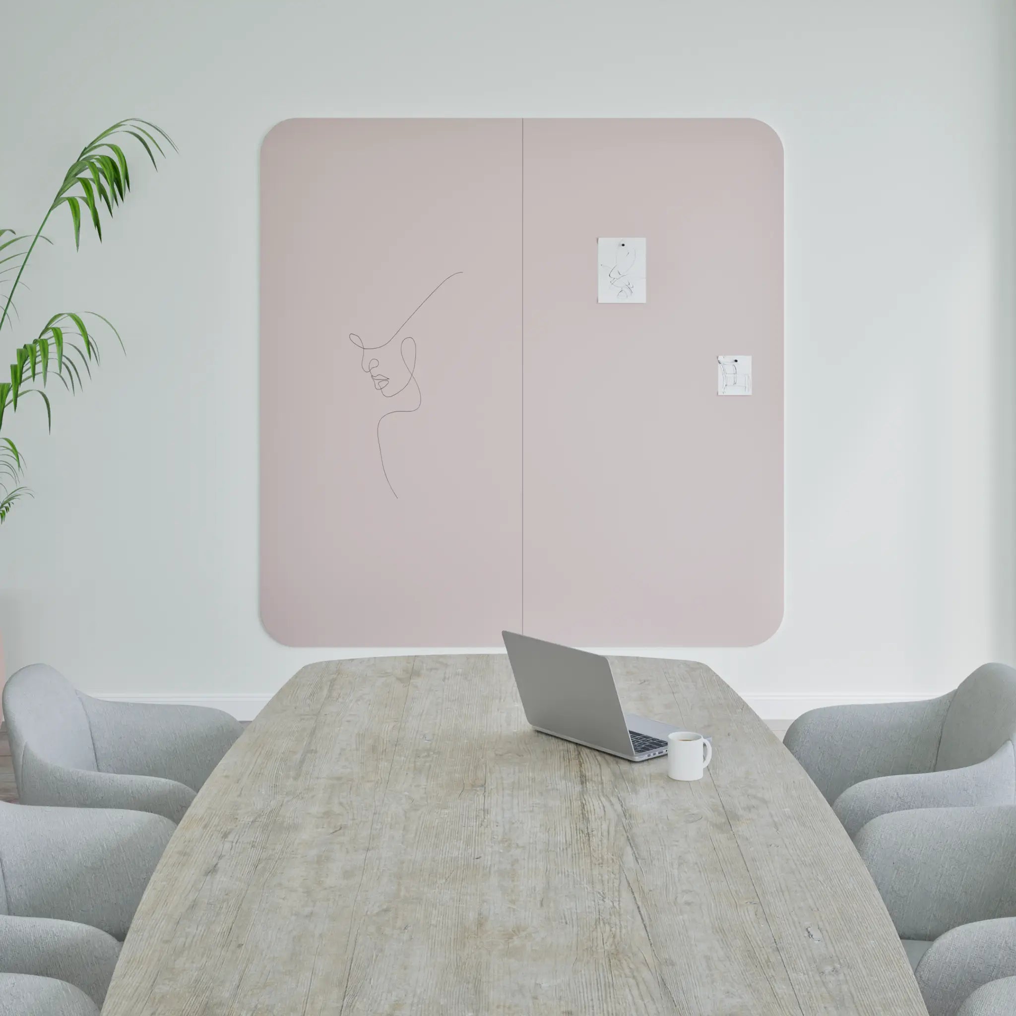 Modern meeting room with wooden table, gray chairs, laptop, Chameleon Curve Wall whiteboard for notes; stylish and minimalist.