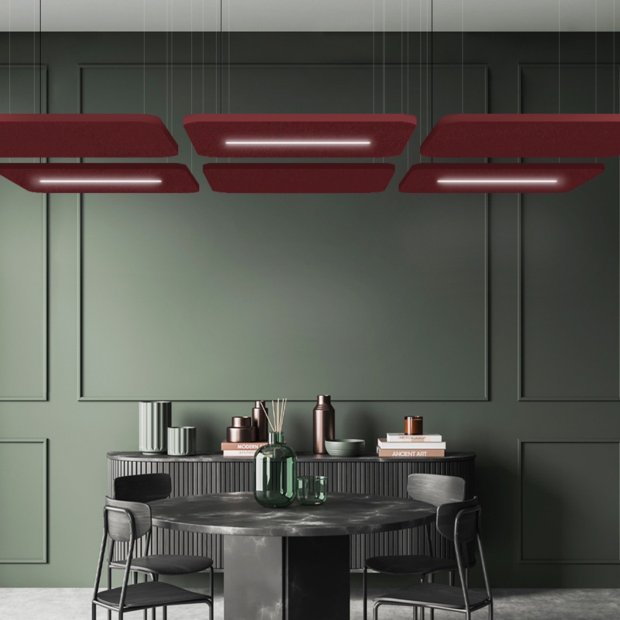 Contemporary dining room with dark green walls, round table, black chairs, vases, and Zen Light Raft maroon acoustic ceiling panels.