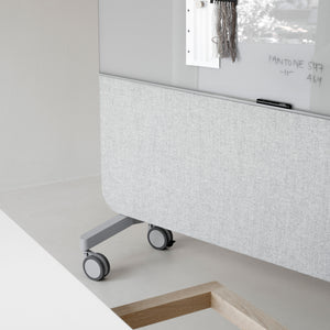 Showcasing the Lintex Mood Fabric partition, featuring a glass board and fabric panel on wheels in a chic modern office space.