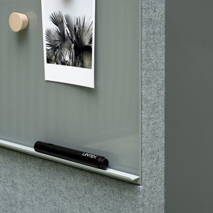 Boost productivity with Lintex Mood Fabric magnetic glass board—palm photo, wooden magnet, black marker on ledge, modern design.