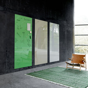 Modern minimalist room with dark walls, large windows, tan leather chair, green rug, and three Lintex Mood Wall magnetic glass boards.