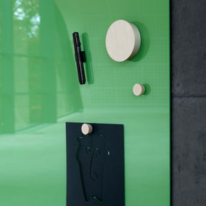 Green Lintex Mood Wall glass magnetic writing board with wooden magnets, black marker, green pen, and minimalist face art.