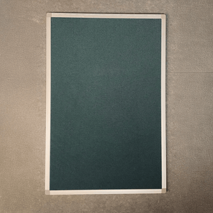 Class 1 fire rated Premier Camira Cara Notice Board with green fabric, aluminium frame, on gray textured wall by Presentation Spaces.