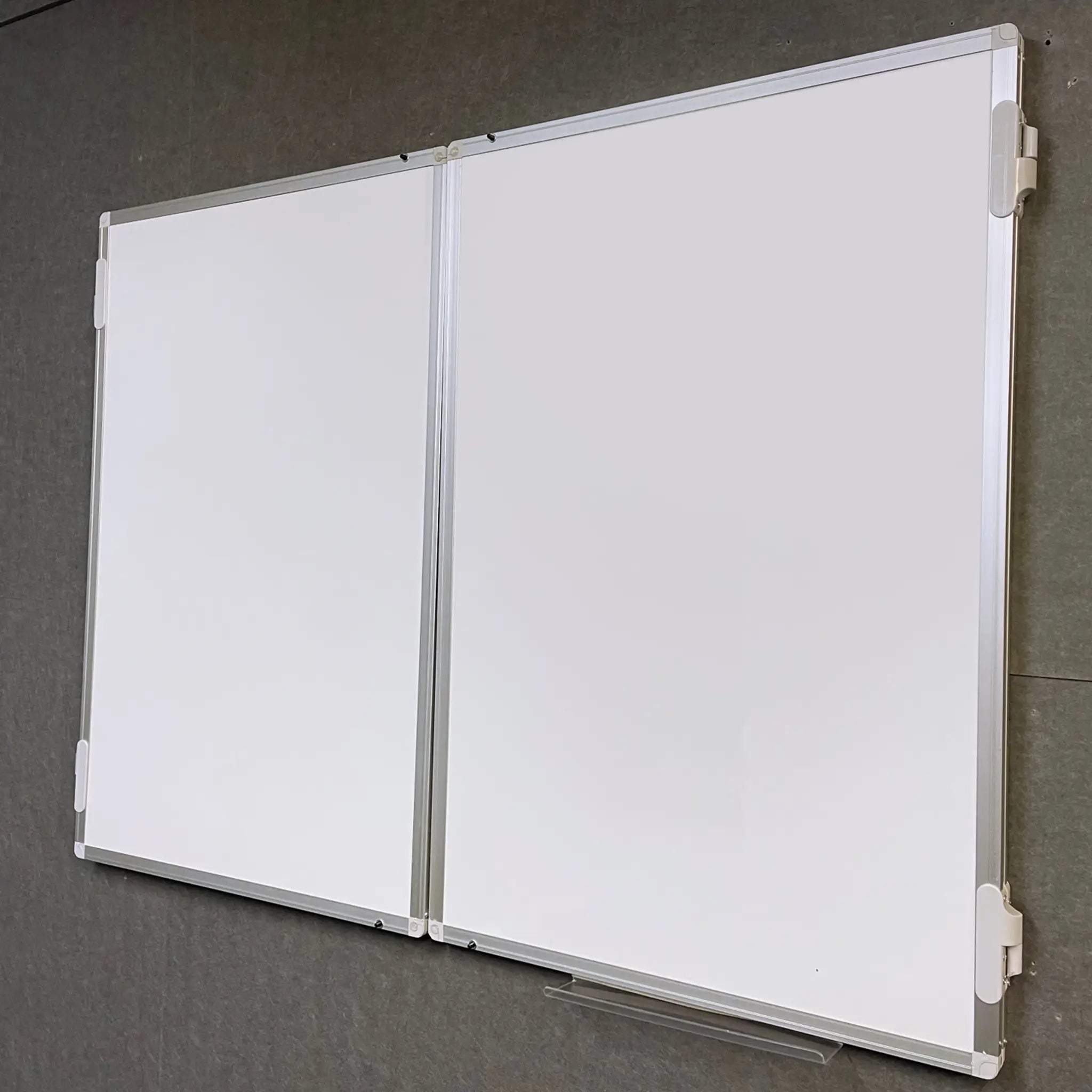 Discover the FR Confidential Lockable Non-Magnetic Whiteboard: dual panels, sleek silver frame, marker tray on a gray wall.