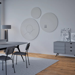 Modern minimalist office with gray furniture, abstract art, and a Chameleon Round Frameless VES Magnetic Whiteboard on wood floor.