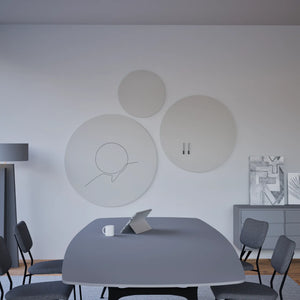 Modern conference room with Chameleon Round Frameless VES Magnetic Whiteboards, long table, six chairs, tablet, and abstract art.