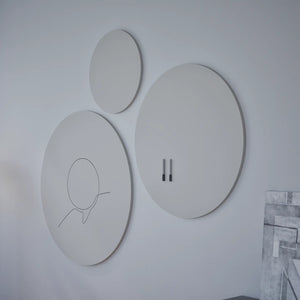 Showcasing three modern round wall art pieces, including the Chameleon VES Magnetic Whiteboard, plus nearby geometric artwork.