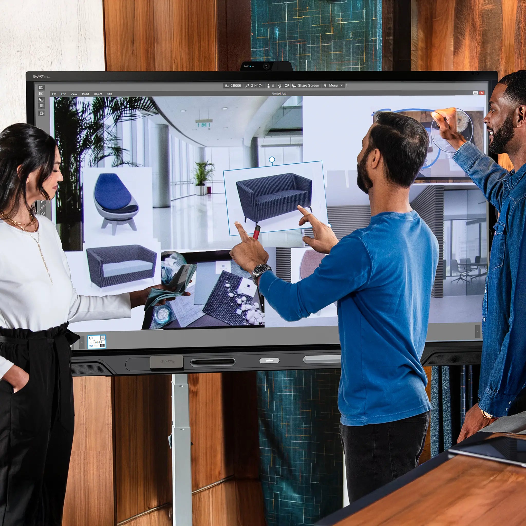 Team collaborates on the SMART QX Pro, arranging furniture designs on its premium touchscreen in a sleek modern office setting.