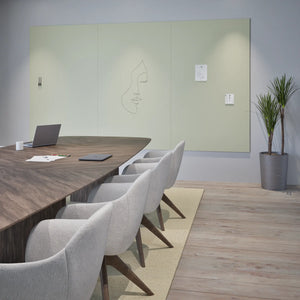 Modern conference room with sleek table, chairs, laptop, notebook, and Chameleon Sharp Wall Frameless VES Magnetic Whiteboard.