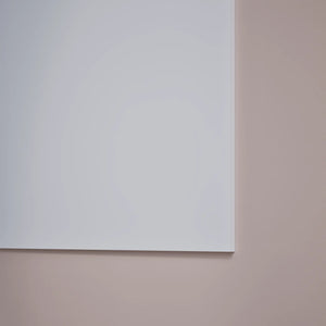 Detailed view of Chameleon Sharp Frameless VES Magnetic Whiteboard’s lower right corner, wall-mounted on a light beige background.