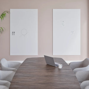 Modern conference room with wooden table, laptop, Chameleon Sharp Frameless VES Magnetic Whiteboards, gray chairs, and plant.