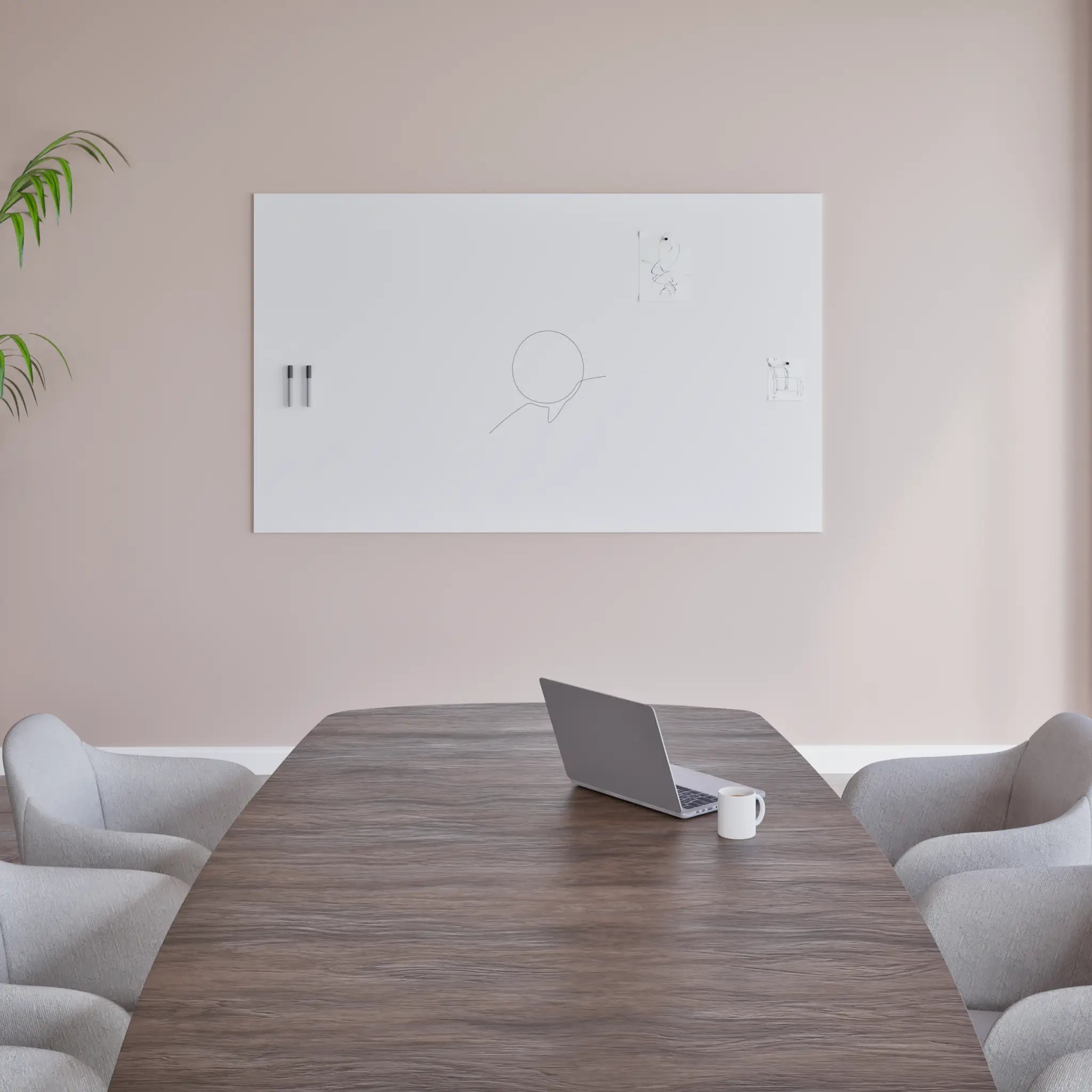 Sleek meeting room with wooden table, gray chairs, open laptop, mug, and Chameleon Frameless VES Magnetic Whiteboard on beige wall.