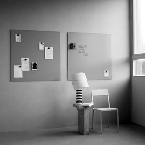 Discover a sleek minimal workspace with Lintex Silk Wall glassboards, modern chair, striped lamp, and stone table by the window.