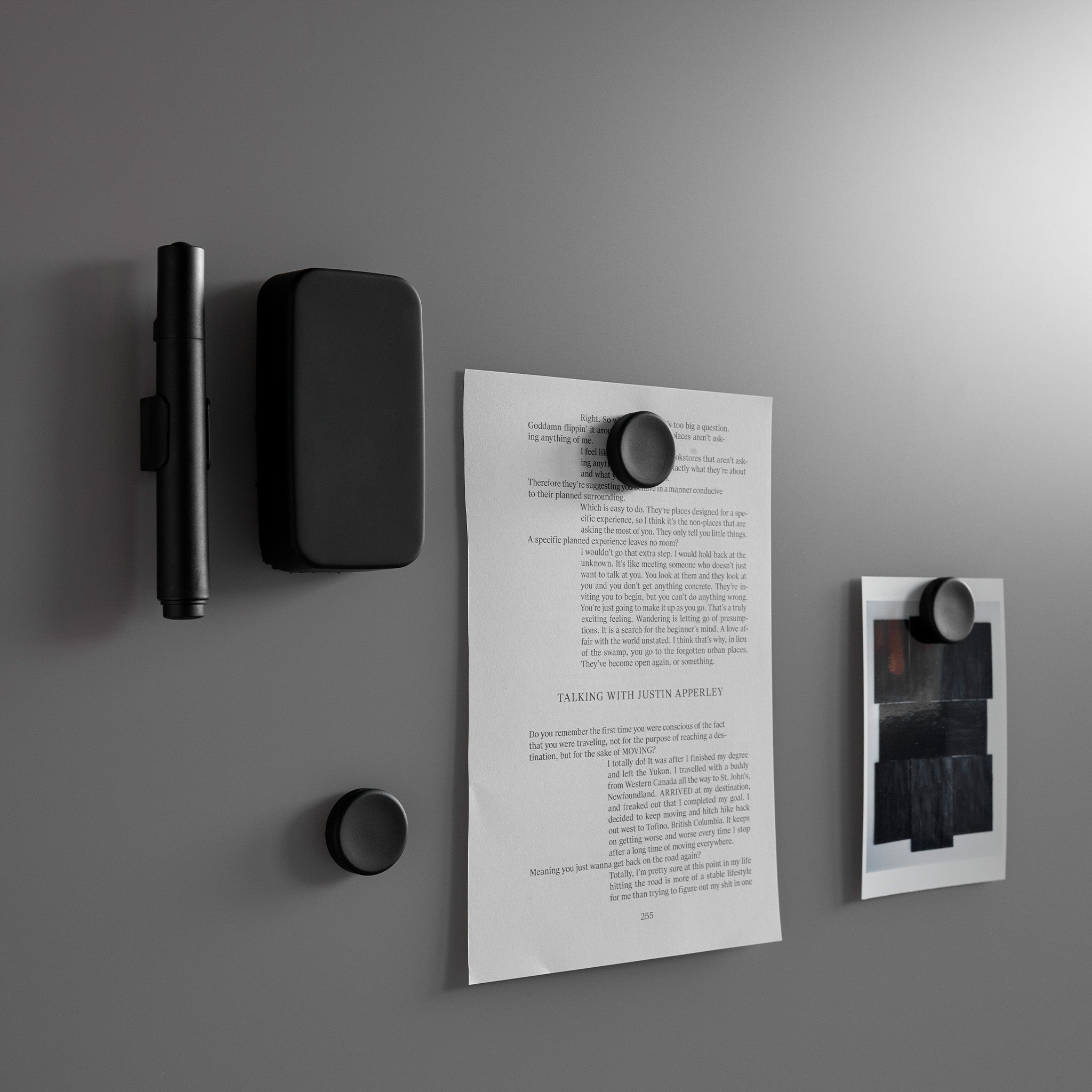 Discover the Lintex Silk Wall: a sleek, gray magnetic board with pen, case, paper, photo, and stylish black magnets on display.