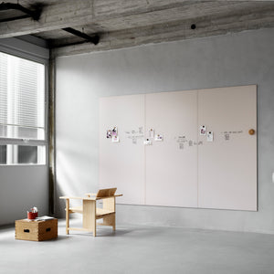 Discover a minimalist office featuring a Lintex Silk Wall magnetic board, wood furniture, and natural light—perfect for productivity.