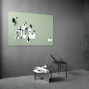 Modern minimalist office with black chair, metallic desk, stationery, and Lintex Silk Wall—green matte glassboard used as bulletin board.