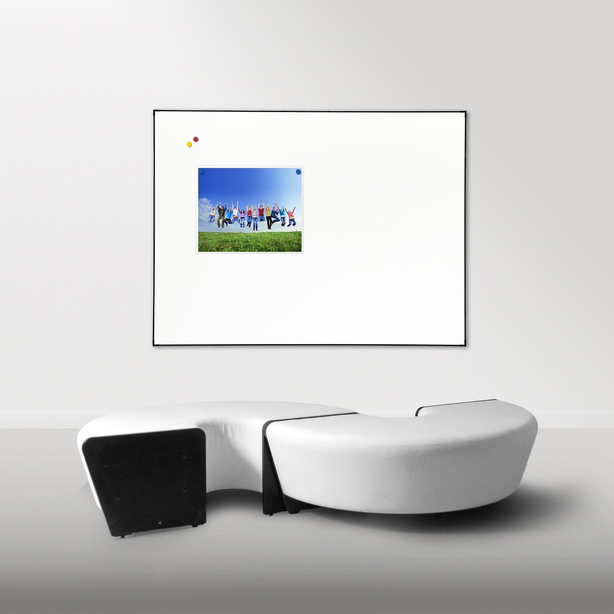 Showcasing the Presentation Spaces Slimline Whiteboard in a chic, modern room with curved sofa and inspiring framed photo decor.
