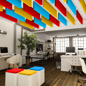 Modern office with wooden floors, white desks, computers, lush plants, and vibrant Zen Baffle panels by Zen Zone for acoustic comfort.