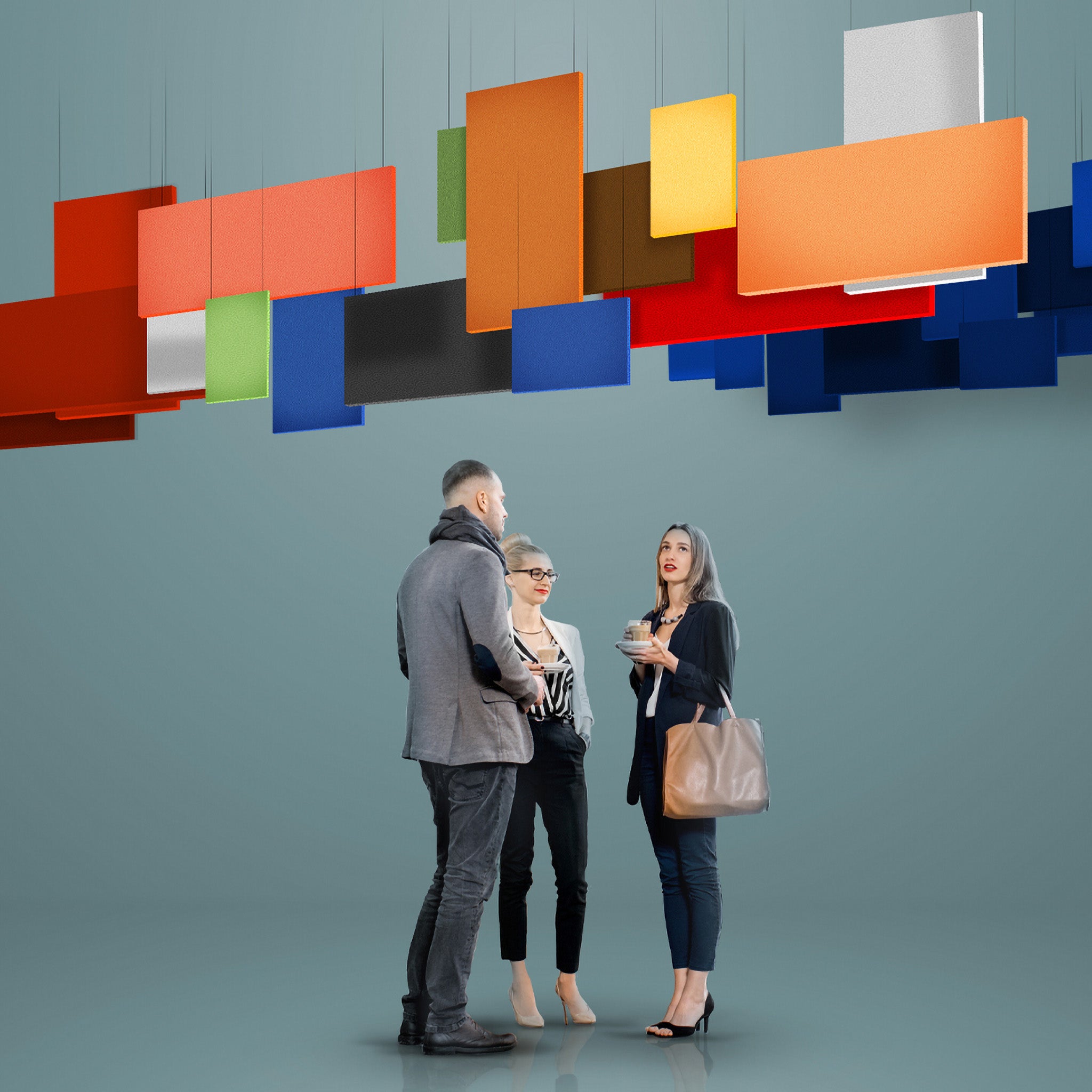Three people chat under Zen Baffle panels by Zen Zone, enhancing acoustics and style in a sleek, modern gray workspace.
