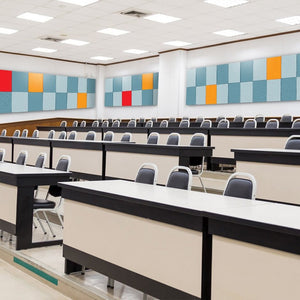 Modern lecture hall with tiered seating, desks, and vibrant Zen Zone Zen Liner acoustic wall panels for a stylish contemporary space.