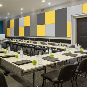 Contemporary conference room with U-shaped tables, Zen Liner panels by Zen Zone in yellow, gray, black; bright and inviting space.
