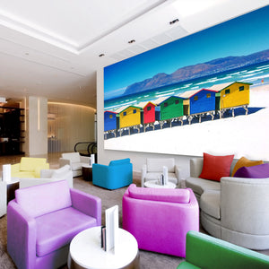 Modern lounge with pastel armchairs, Zen Zone photo panels for sound absorption, and a vibrant beach hut mural on the wall.