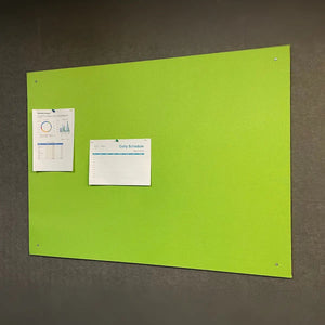 Wall-mounted Camira Lucia notice board with green fabric, pinned data chart and schedule; ideal for secure global workplaces.