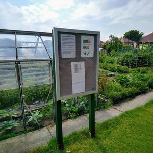 Weatherproof noticeboard by Presentation Spaces, ideal for secure global workplace updates in any climate or location, outdoors.